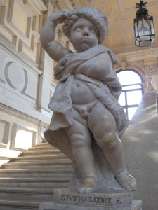 A cherub dressed as Winter greets guests on the main staircase